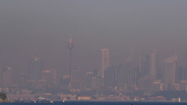 A thick a blanket of smoke hangs over parts of...