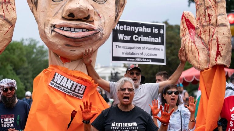 Demonstrators protest the visit of Israeli Prime Minister Benjamin Netanyahu...