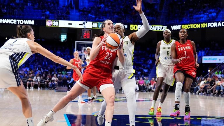 Indiana Fever's Caitlin Clark (22) drives to the basket for...