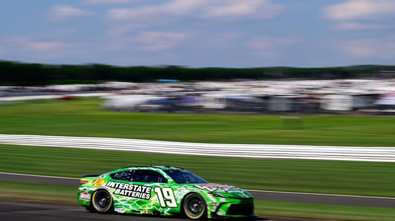 Martin Truex Jr. drives through Turn 3 during a NASCAR...