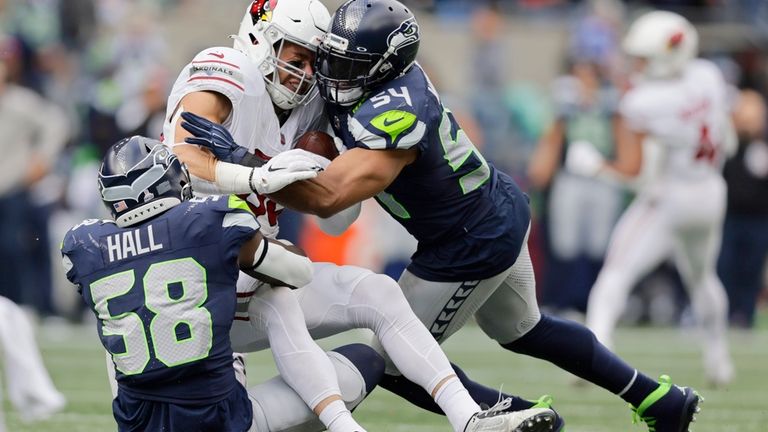 Arizona Cardinals tight end Zach Ertz, center, gets tackled by...