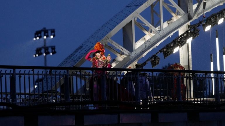 Drag queens prepare to perform on the Debilly Bridge in...