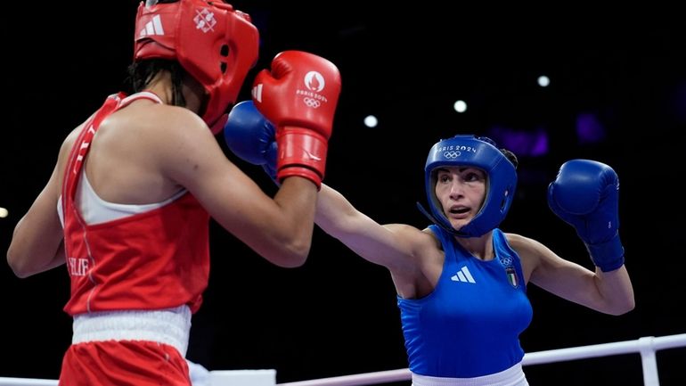 Algeria's Imane Khelif, left, fights Italy's Angela Carini in their...