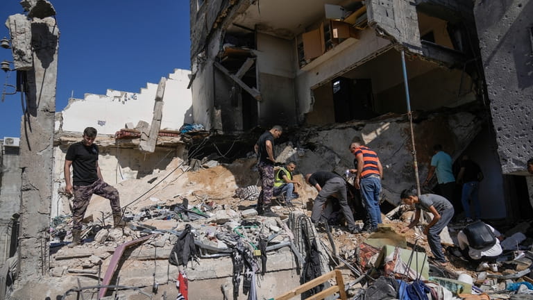 Palestinians inspect the destruction following an Israeli operation in Nur...