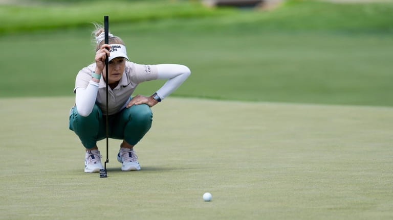Nelly Korda measures her putt on the fourth green during...