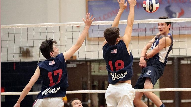 Eastport-South Manor's Robert Choma follows through on the spike against...