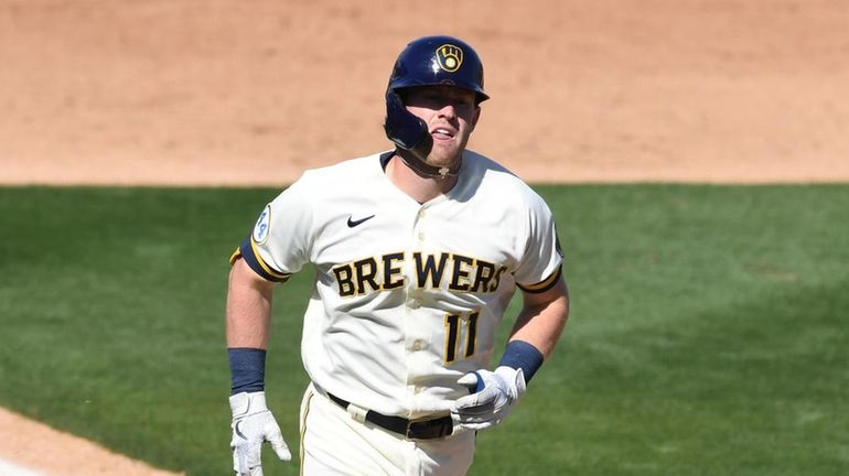 Billy McKinney #11 of the Milwaukee Brewers rounds the bases...