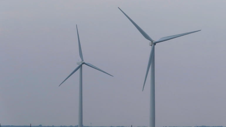 Land-based wind turbines turn in Atlantic City, N.J. on July...