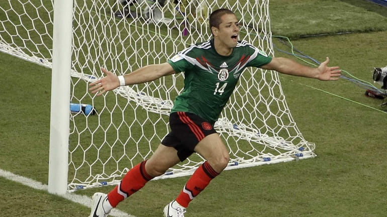 Mexico's Javier Hernandez (14) celebrates scoring his side's third goal...