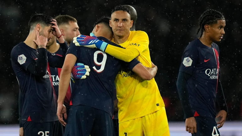 PSG's goalkeeper Keylor Navas embraces PSG's Goncalo Ramos after the...