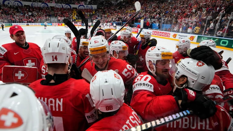 Switzerland's players celebrate after the semifinal match between Canada and...