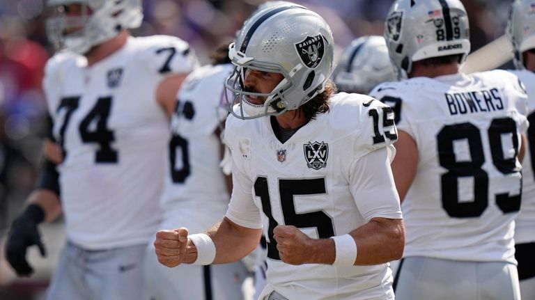 Las Vegas Raiders quarterback Gardner Minshew (15) celebrates after running...