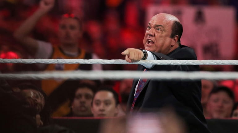 Manager Paul Heyman communicates with Brock Lesnar at WrestleMania XXXI...