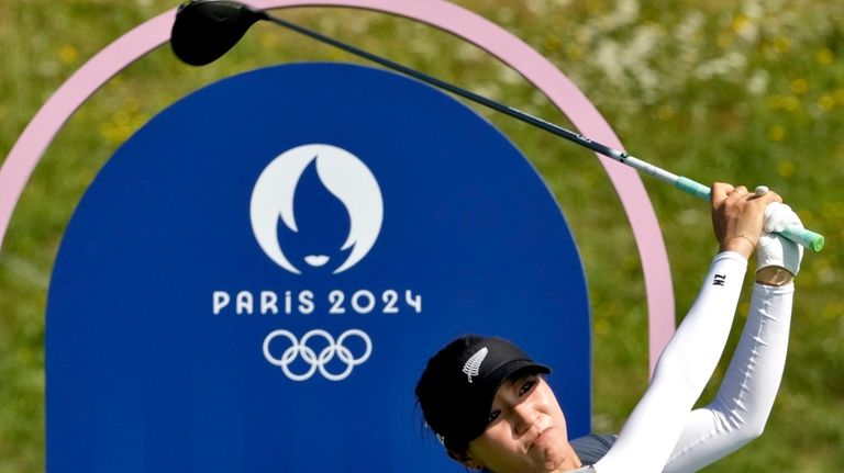 Lydia Ko, of New Zealand, hits from the third tee...