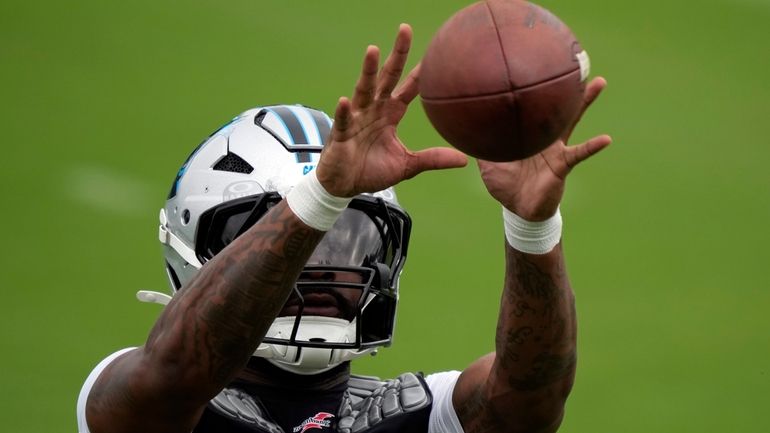 Carolina Panthers running back Miles Sanders reacts for a catch...