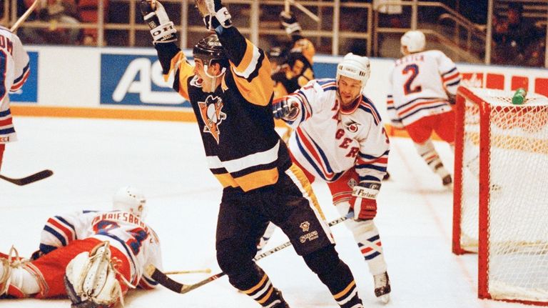 Pittsburgh Penguins Kevin Stevens celebrates teammate Jaromir Jagr's second goal...