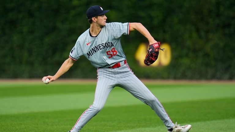 Minnesota Twins starting pitcher David Festa warms up before a...