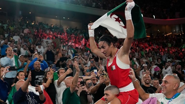 Algeria's Imane Khelif celebrates after defeating China's Yang Liu to...