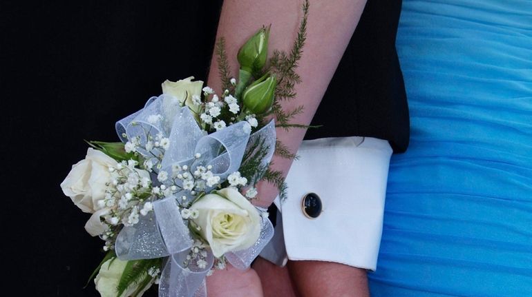 A couple posing at prom.