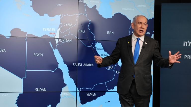 Israeli Prime Minister Benjamin Netanyahu stands before a map during...