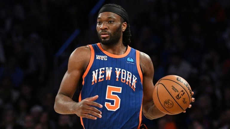 Knicks forward Precious Achiuwa brings the ball up court against...