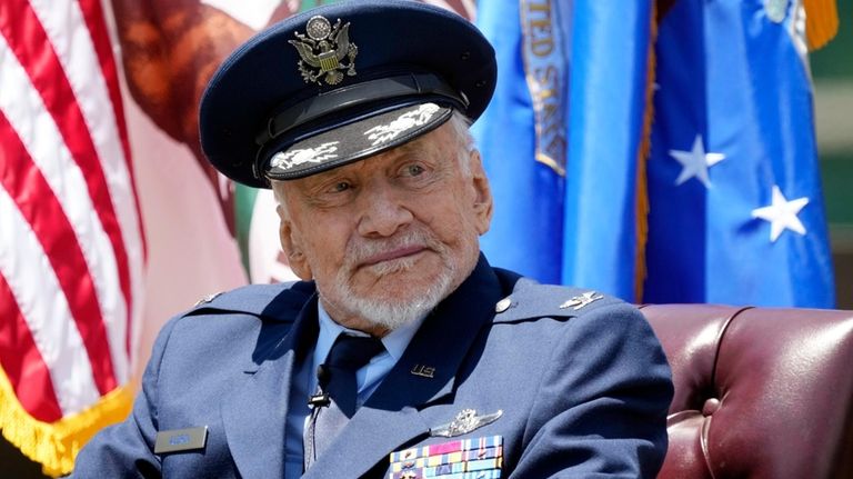 U.S. Air Force Col. Buzz Aldrin, retired, listens to a...