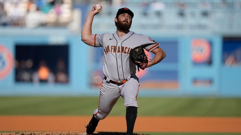 San Francisco Giants starting pitcher Ryan Walker (74) throws during...