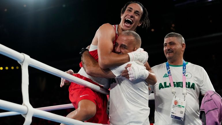 Algeria's Imane Khelif celebrates after defeating China's Yang Liu to...