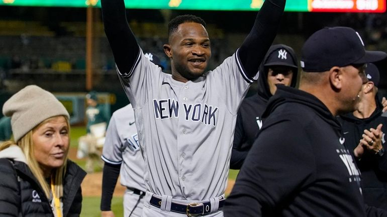 The Yankees' Domingo Germán, center, celebrates after pitching a perfect...