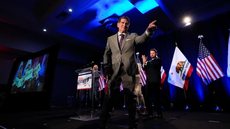 Republican U.S. Senate candidate Steve Garvey points to his supporters...