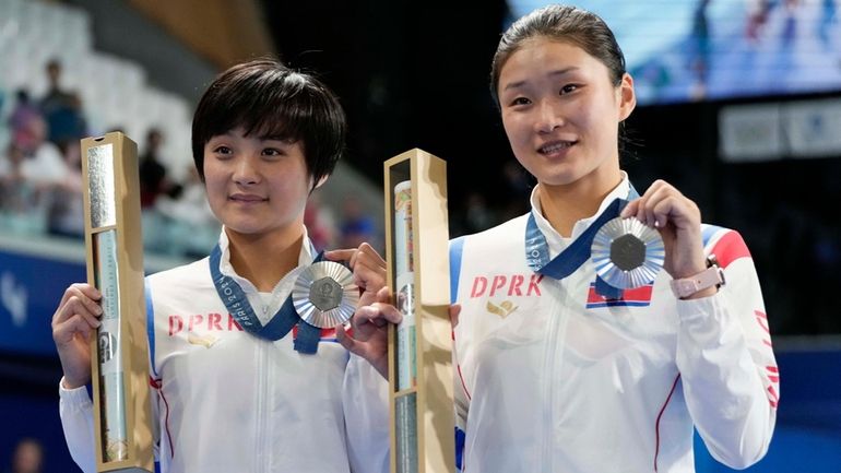 North Korea's Jo Jin Mi and Kim Mi Rae pose...