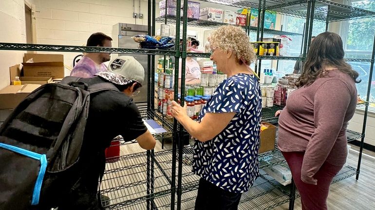 Food pantry volunteer Diane Butler works at St. Paul's Episcopal...