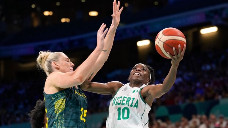 Promise Amukamara, of Nigeria, shoots around Lauren Jackson, of Australia,...