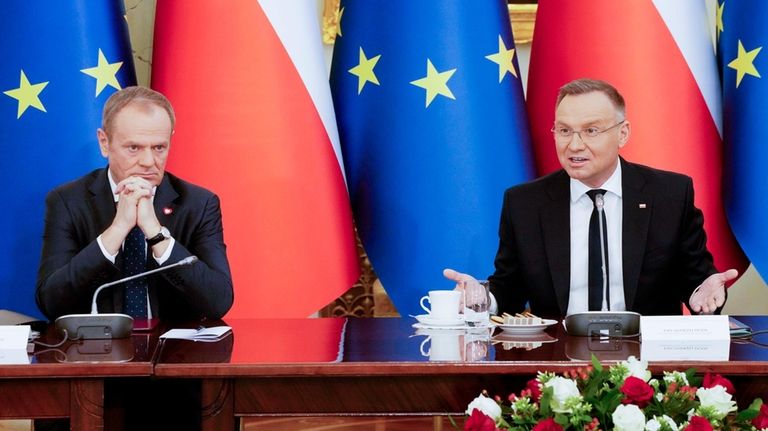 Poland's Prime Minister Donald Tusk, left, and President Andrzej Duda...