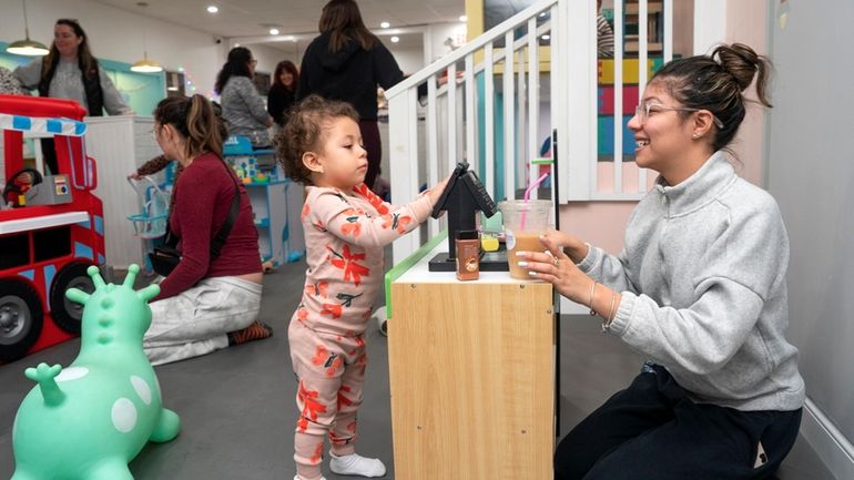 Karen Saravia plays with her neice Penelope Velasquez, both of...