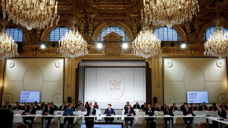 French President Emmanuel Macron, center, delivers a speech at the...