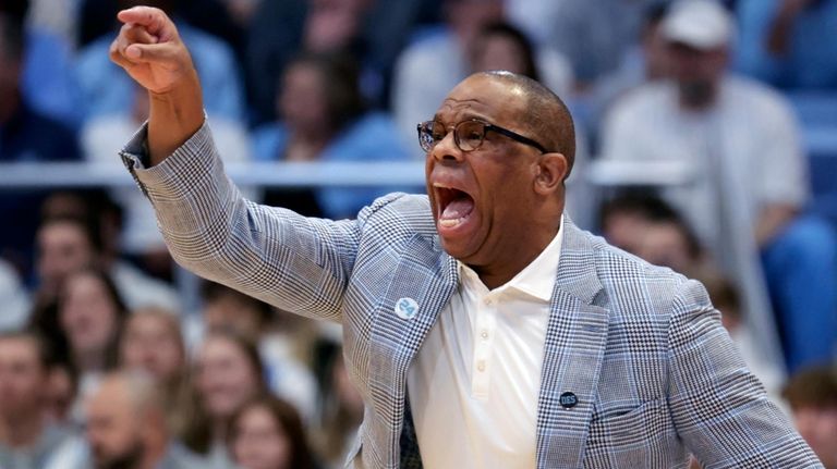 North Carolina head coach Hubert Davis directs the team as...