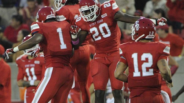 Stony Brook wide receiver Adrian Coxson, left, celebrates his touchdown...