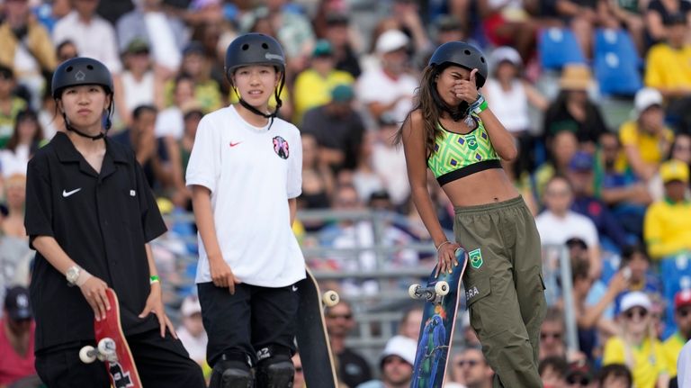 Rayssa Leal, of Brazil, right, gestures during the women's skateboard...