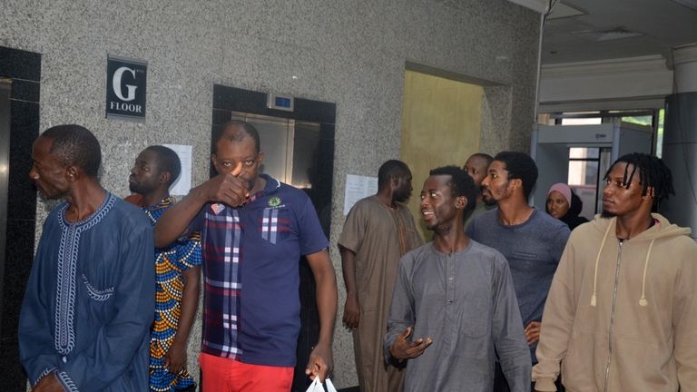 Protesters walk after a court hearing in Abuja, Nigeria, Monday,...