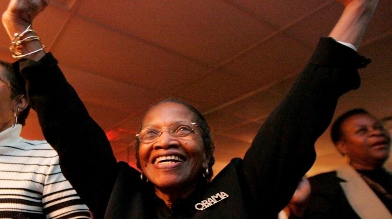 Obama supporter Bernice Burnett and others cheer as they hear...