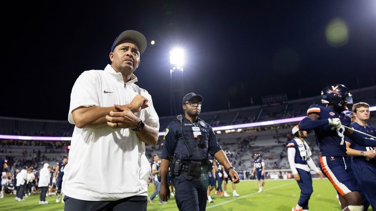 Virginia head coach Tony Elliott walks toward the sideline after...