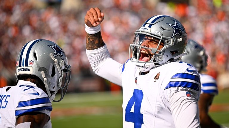 Dallas Cowboys quarterback Dak Prescott (4) celebrates after throwing a...