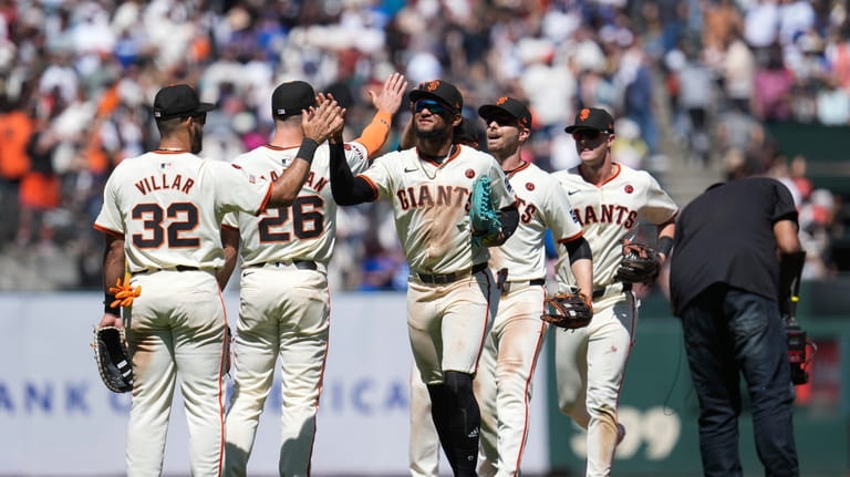 The San Francisco Giants celebrate after their victory over the...