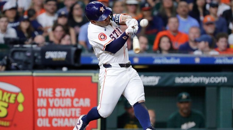 Houston Astros' Jose Altuve connects for his one-run RBI single...