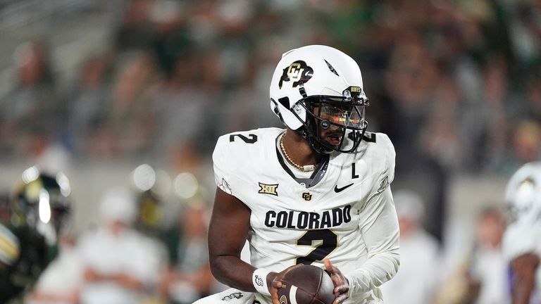 Colorado quarterback Shedeur Sanders turns to hand off the ball...