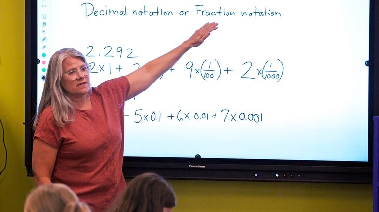 File - Math teacher Margie Howells teaches a fifth grade...