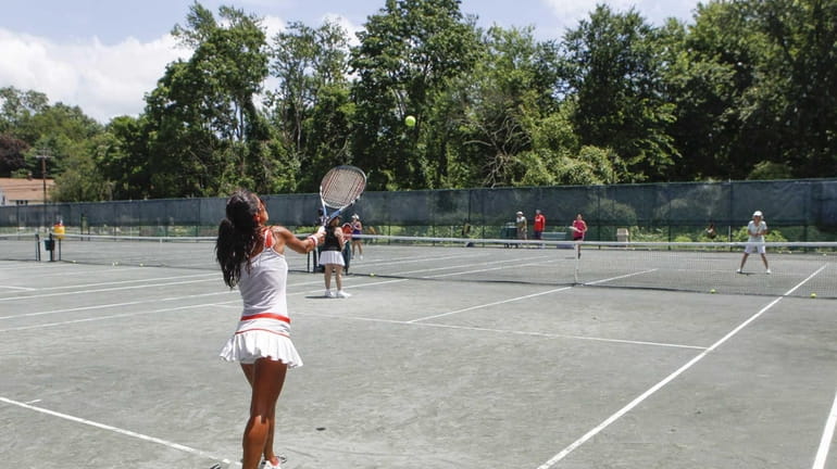 Naz Chafe, from Great Neck, takes swings during a tennis...