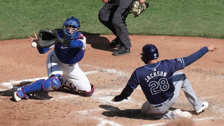 Tampa Bay Rays' Alex Jackson (28) scores ahead of a...