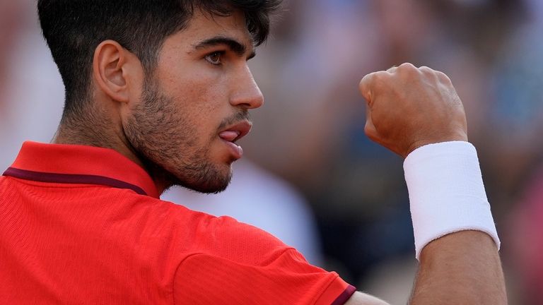 Carlos Alcaraz of Spain reacts after scoring a point against...